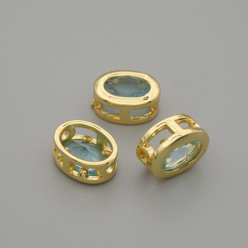 Himmelblaue Einlegeperle mit Kristall in Goldfassung, oval, Durchmesser ca. 9×7 mm, Lochdurchmesser ca. 1,3 mm, pro Stück