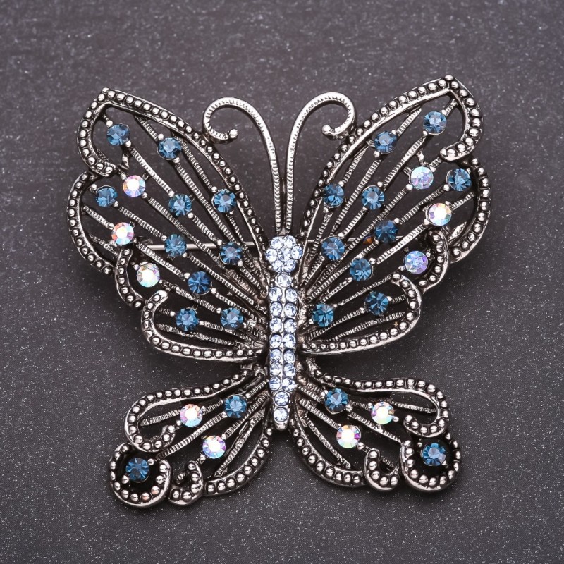 Brosche Schmetterling mit blauen Strasssteinen 53 × 54 mm, graues Metall