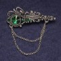 Brosche 'Akzent' mit grünen Strasssteinen und Kristall, silberfarbenes Metall, 55×22 mm